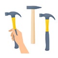 Human hand holds hammer. Hammers with wooden and plastic handles Royalty Free Stock Photo