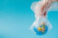 The human hand holds the planet earth in a plastic bag. The concept of pollution by plastic debris. Global warming due to Royalty Free Stock Photo