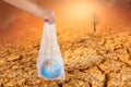 The human hand holds the planet earth in a plastic bag. The concept of pollution by plastic debris. Global warming due to Royalty Free Stock Photo