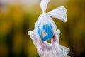 The human hand holds the planet earth in a plastic bag. The concept of pollution by plastic debris. Global warming due to Royalty Free Stock Photo