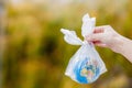 The human hand holds the planet earth in a plastic bag. The concept of pollution by plastic debris. Global warming due to Royalty Free Stock Photo