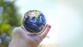 Human hand holds small Earth with care and love. Royalty Free Stock Photo