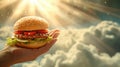 A human hand holds a tasty hamburger, on the background of the heavenly paradise