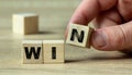 Human hand holds a winning wooden block in the game