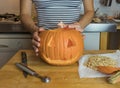 Human hand inserting candle in pumpkin Royalty Free Stock Photo