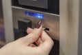 human hand inserting a coin in a vending machine. Royalty Free Stock Photo