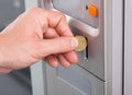 Human hand inserting coin in vending machine Royalty Free Stock Photo