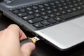 Human hand inserting USB flash drive into laptop computer close up Royalty Free Stock Photo