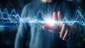 Human hand interacting with a glowing digital interface displaying colorful sound wave data visualizations and light Royalty Free Stock Photo