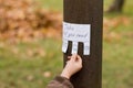 Human hand keeps for handwritten ad with weather icons