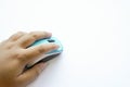 human hand on a light blue wireless mouse Royalty Free Stock Photo