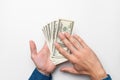 human hand with money on a white background. male hands in a shirt hold out and spend one hundred dollar bills Royalty Free Stock Photo