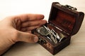 Human hand next to a small chest of Russian ruble coins Royalty Free Stock Photo