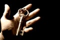 Human hand with an old key Royalty Free Stock Photo