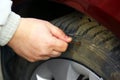 Human hand piercing the tire wheel