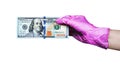 Human hand in pink rubber medical glove holds one hundred us dollar banknote on white background isolated closeup viral protection Royalty Free Stock Photo