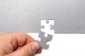 Human hand placing a piece of a puzzle Royalty Free Stock Photo