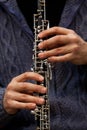 Human hand playing the oboe