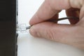 Human hand plugging in a LAN cords Royalty Free Stock Photo