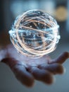 Human hand presenting a glowing futuristic orb made of intertwined light trails and particles symbolizing technology, innovation, Royalty Free Stock Photo