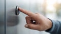 Human hand pressing a call button on a metallic elevator panel. Showing accessibility and interaction with building transportation Royalty Free Stock Photo