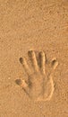 Human hand print on sand of beach with empty space Royalty Free Stock Photo