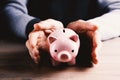 Human hand protecting a piggy bank Royalty Free Stock Photo