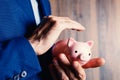 Human hand protecting a piggy bank Royalty Free Stock Photo