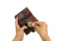 Human hand puts golden coin of bitcoin in brown leather purse, i Royalty Free Stock Photo
