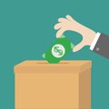 Human hand putting paper money bill with dollar sign into donation paper cardboard box. Helping hands concept. Donate and help. Royalty Free Stock Photo