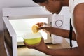 Human Hand Putting Sliced Lemon In Bowl Royalty Free Stock Photo