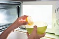 Human Hand Putting Sliced Lemon In Bowl Royalty Free Stock Photo