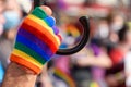 human hand in rainbow color glove. LGBT rainbow flag on foreground as a symbol of equality rights Royalty Free Stock Photo