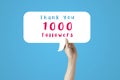 Human hand raised up and holding a bubble speech of thank you 1000 followers