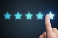 Human hand is rating with 5 stars. Ranking and customer satisfaction concept