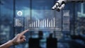 Human Hand Interacting with Robotic Hand Displaying Data Visualization in Modern Office Environment with Digital Graphs Royalty Free Stock Photo