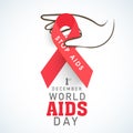 Human hand with red aids ribbon for World Aids Day concept.