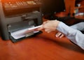 Human hand is reloading the paper to printer tray Royalty Free Stock Photo