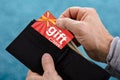 Human Hand Removing Gift Card From Wallet