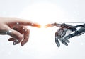 Human hand touching robotic hand with glowing digital connection Royalty Free Stock Photo