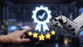Hand of Human and Robotic Arm Reaching for Digital Badge with Stars Signifying Quality and Excellence in Technology and Royalty Free Stock Photo