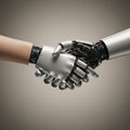 A human hand and a robotic hand are joined in a handshake against a neutral background Royalty Free Stock Photo