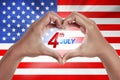 Human hand in shape of love with 4th of July text