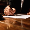 Human hand signing contract with a noble pen on a wooden table created with Generative AI