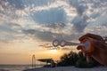 Human hand with soap bubble stick against evening seascape. Dramatic sunset on the beach. Summer leisure activity. Royalty Free Stock Photo