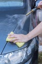 Human hand with sponge soap washing car Royalty Free Stock Photo