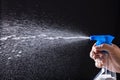 Human Hand Spraying Water With Spray Bottle