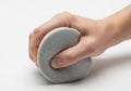 Human hand squeezing a compressible gray circular foam or sponge object Royalty Free Stock Photo