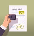 human hand stamping legal document CO2 limit emissions idea net zero emission carbon credit offset concept