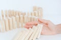 Human hand starting a domino effect concept Royalty Free Stock Photo